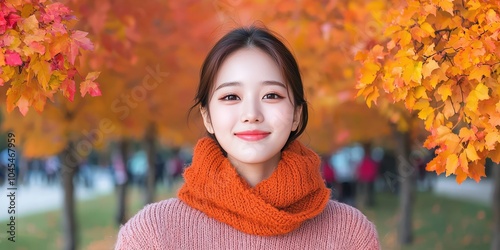 Young Woman Smiling in Autumn Park with Red and Yellow Leaves