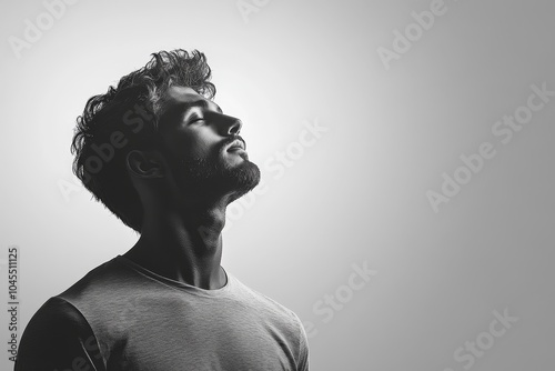 Wallpaper Mural black and white male silhouette on light background, caucasian man looks up with his eyes closed, copy space, portrait Torontodigital.ca
