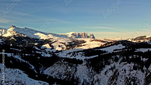 Aerial footage capturing the golden sunrise over the snowy slopes of Schlern and Seiser Alm in the Dolomites. Dolomiti Superski photo