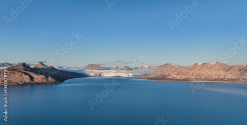 Exploring Nordenskiold Glacier in Svalbard under clear blue skies and serene waters