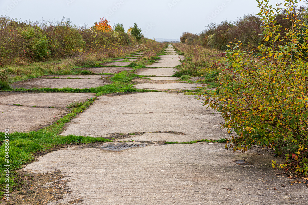 The remains of the concrete runway of the Second World War airfield of RAF Broadwell near the village of Kencot, Oxfordshire, England UK