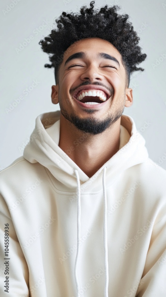 Fototapeta premium A man with a beard and a smile on his face is wearing a white hoodie