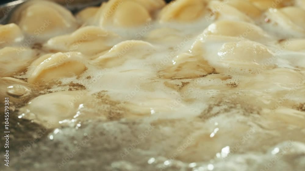 Cooking boiling Meat frozen dumplings in restaurant, Ukranian, polish, Russian traditional pelmeni cooking process, vareniki ravioli pierogi, north cuisine. Cooking boiling Meat frozen dumplings in restaurant, Ukranian, polish, Russian traditional pelmeni cooking process, vareniki ravioli pierogi, north cuisine.