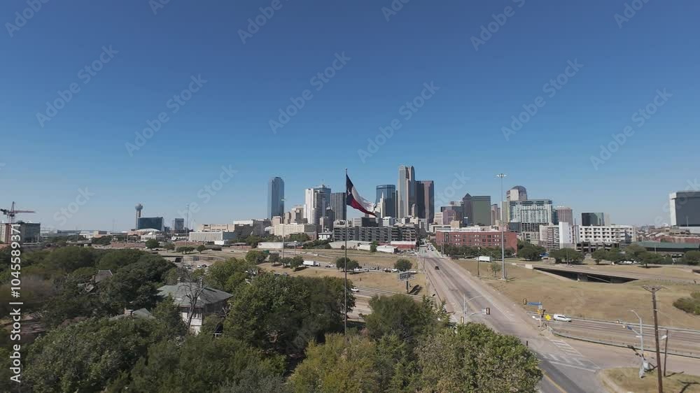 Dallas, TX USA - October 20, 2024: Aerial video of Texas flag blowing in the wind in front of the downtown Dallas skyline. Dallas, TX USA - October 20, 2024: Aerial video of Texas flag blowing in the wind in front of the downtown Dallas skyline.