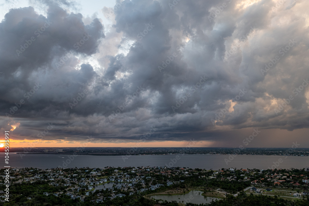 Storm Clouds Gathering Over Coastal City at Sunset. Storm Clouds Gathering Over Coastal City at Sunset.