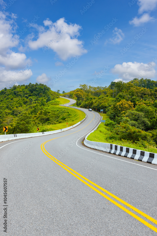 Obraz premium Popular view point of double s-curve road up to the hill with green tree and sky, called curve number 3 at Nan province, Northern of Thailand
