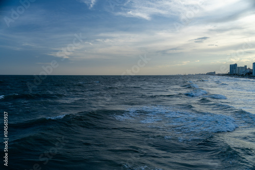 Urban Coastline at Sunset with Ocean Waves