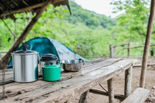 Cozy rustic campsite featuring a small tent and cooking utensils surrounded by lush greenery