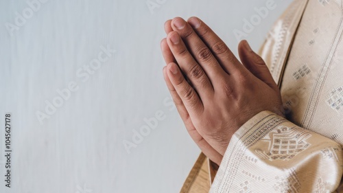 A Person in Traditional Attire With Hands Placed Together in Prayer Indoors at a Serene Location