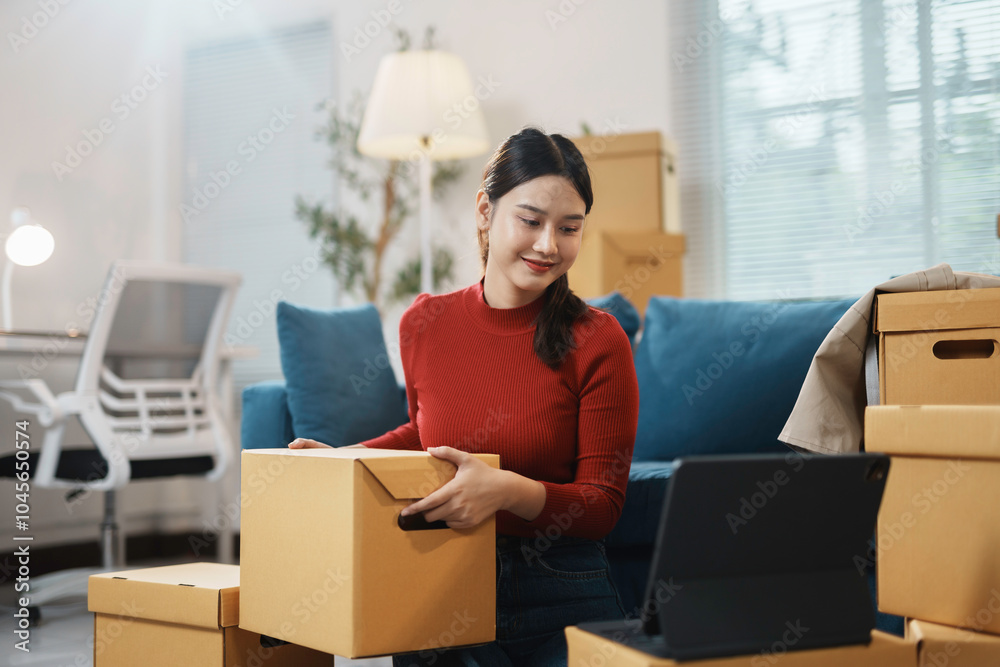 Woman happily unpacks in her new apartment, using a tablet for a video call, making her new place feel like home Woman happily unpacks in her new apartment, using a tablet for a video call, making her new place feel like home