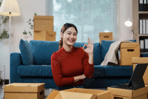 Smiling woman unpacks in her new apartment, surrounded by boxes and furniture, radiating happiness and contentment