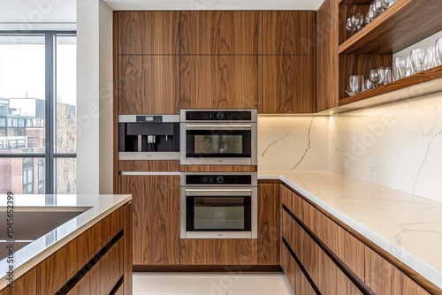 Modern kitchen with walnut cabinets and white walls, featuring an oven in the center of one wall