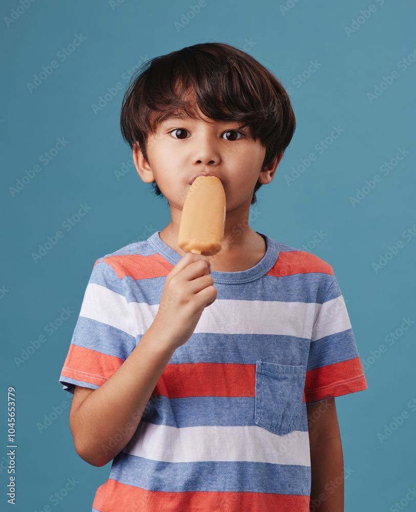 Japanese boy, portrait and popsicle in studio background with sweet snack or sucker in Japan. Male person, kid and eating in confident with unhealthy food, dessert and treat with candy or ice cream Japanese boy, portrait and popsicle in studio background with sweet snack or sucker in Japan. Male person, kid and eating in confident with unhealthy food, dessert and treat with candy or ice cream
