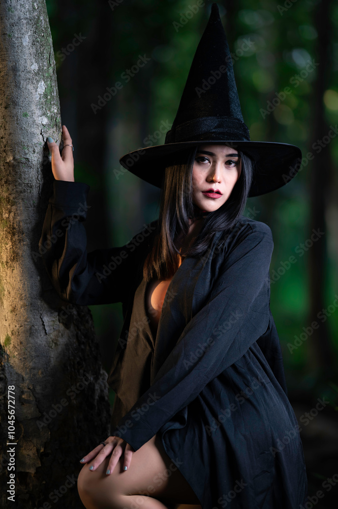 Portrait of beautiful asian sexy woman wear black witch costume with broom,Halloween festival concept
