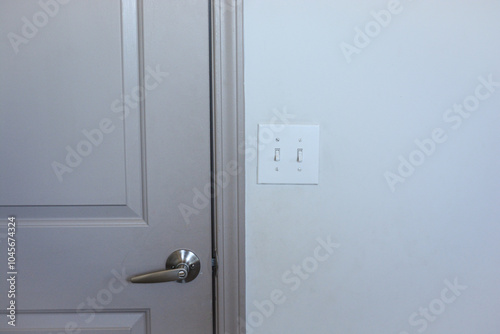 Switch board next to the door, door handle with switch board image, closed door with switch board