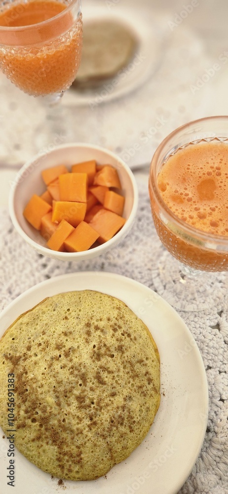 breakfast table with juice and fruits and pancakes breakfast table with juice and fruits and pancakes