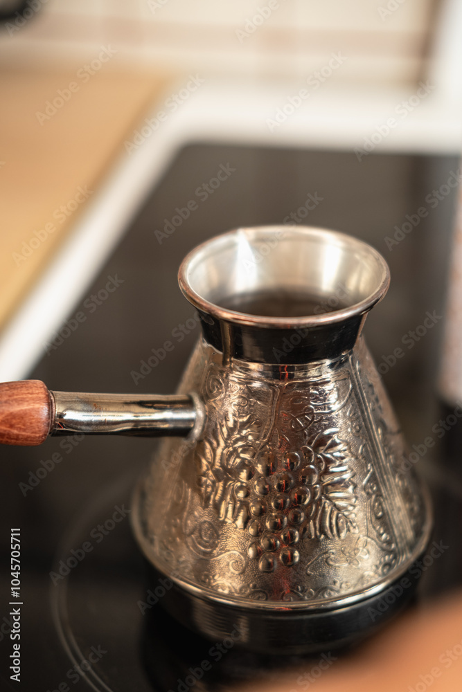 Making Turkish coffee in turk or cezve. Brewing coffee in the morning at home. Making Turkish coffee in turk or cezve. Brewing coffee in the morning at home.