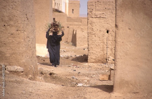Women in nikab walking in a street of Shibam, Yemen,