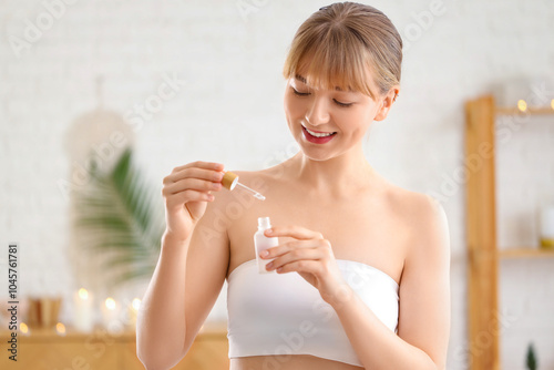 Young woman with bottle of ...