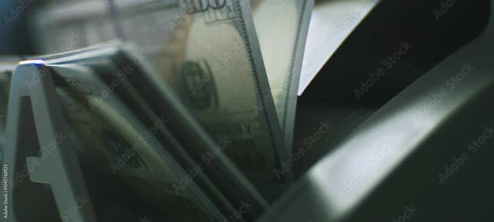 Extreme close-up view of digital money counting machine American dollar banknotes. Fast Dollar currency rotation in slow-motion