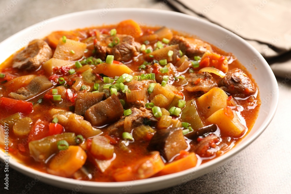 Delicious stew with vegetables in bowl on table, closeup Delicious stew with vegetables in bowl on table, closeup