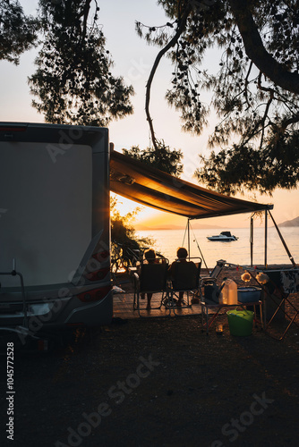 Family traveling with motorhome. Camping in Greece at dawn. Camping holiday at sea. photo