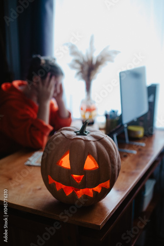 Wallpaper Mural Caucasian happy girl orange color cloths near carved Halloween pumpkin studying online laptop Torontodigital.ca