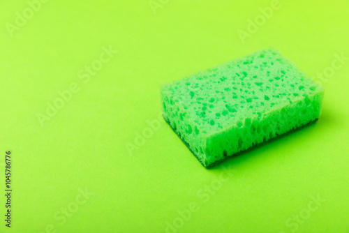 Colorful dish sponges on textured background. Kitchen sponge. Cleaning concept, cleaning service. Dishwashing liquid with clean and dirty dishes plate. Place for text, copy space. Wash the dishes. photo