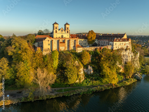 Obraz na płótnie Tyniec near Krakow, Poland. Active Benedictine abbey, monastery and church on the rocky cliff and Vistula River in autumn in sunset light with trees in fall colors w salonie
