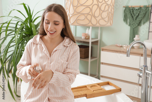 Young woman applying cosmet...