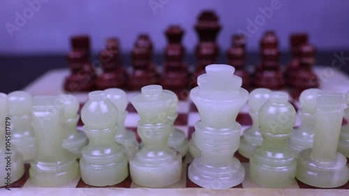 Chess set close up Figures ready for opening move. Whites in focus. Dolly