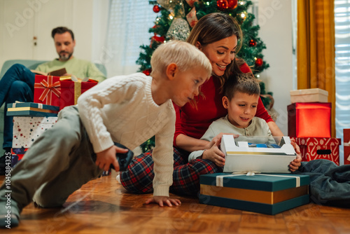 Family opening presents together on christmas morning