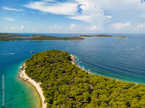 Fototapeta Naklejka Na Ścianę i Meble -  Aerial view of wonderful, green peninsula and white beaches with islands on the horizon at the Rogoznica archipelago, Croatia