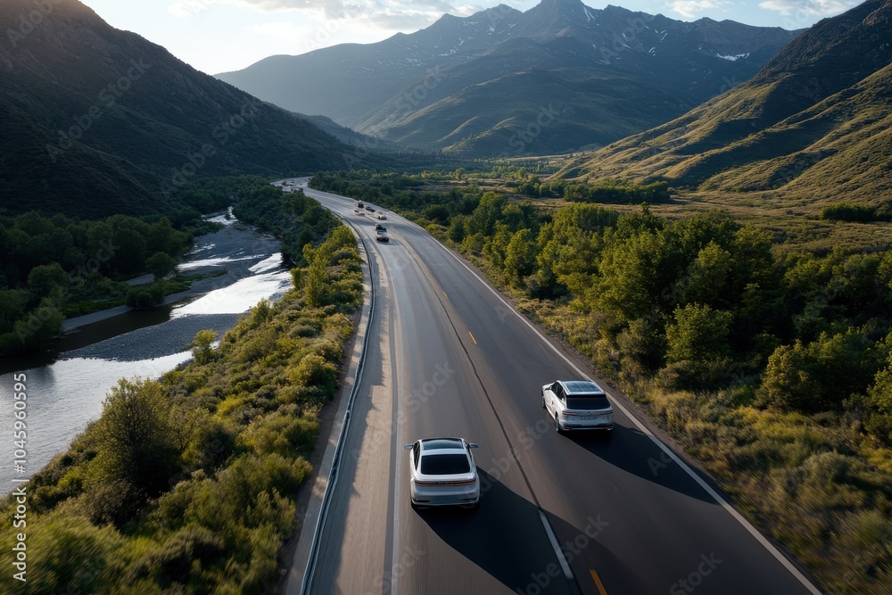 Obraz premium The image captures a road trip along a scenic path, bordered by lush foliage and high mountain peaks, conveying the spirit of exploration and natural wonder.