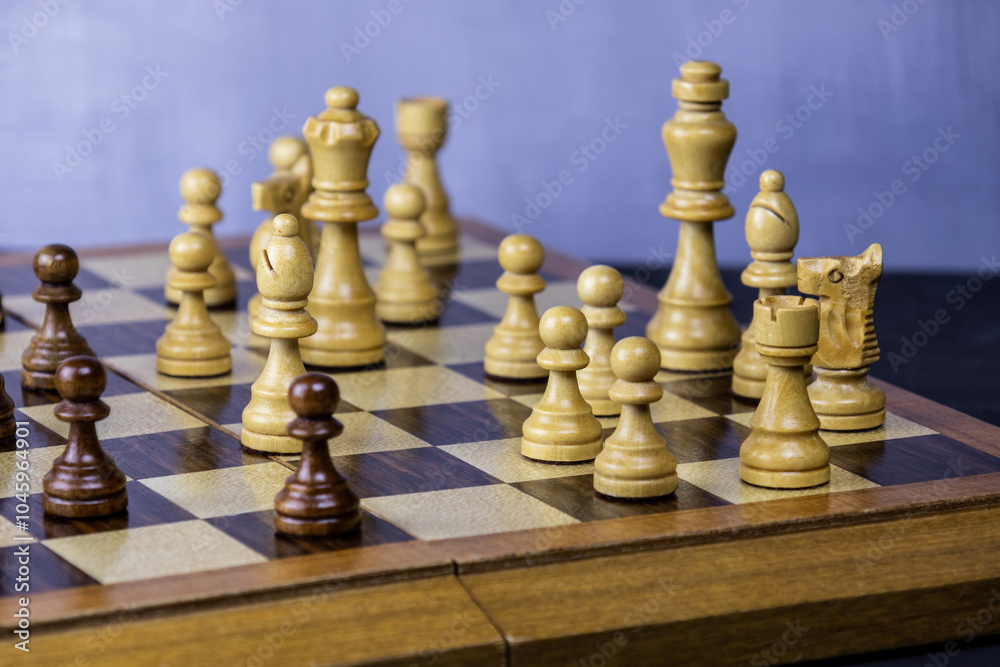 White wooden chess figures are standing strong during the match White wooden chess figures are standing strong during the match