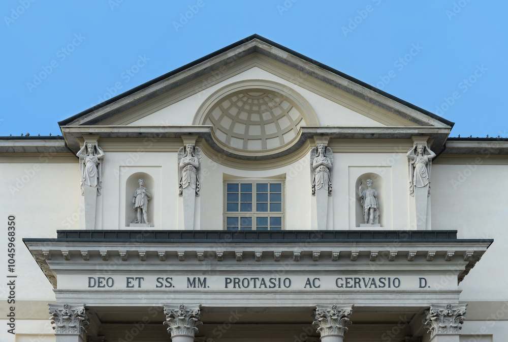 Top gable of the church of the holy martyrs Protasio and Gervasio with blue sky in Gorgonzola, Italy Top gable of the church of the holy martyrs Protasio and Gervasio with blue sky in Gorgonzola, Italy