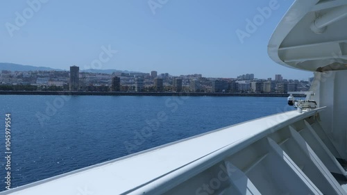 View from a cruise ship as it approaches the Gran Canaria coastline, capturing the city’s skyline and clear blue waters under a bright sky.