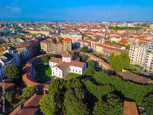 Aerial view of the Rotunda della Besana. Blue sky. Historical buildings in the city. A cruciform church surrounded by a wall. Cinematic drone. Tiled roofs. architecture Milan Italy 22.04.2025