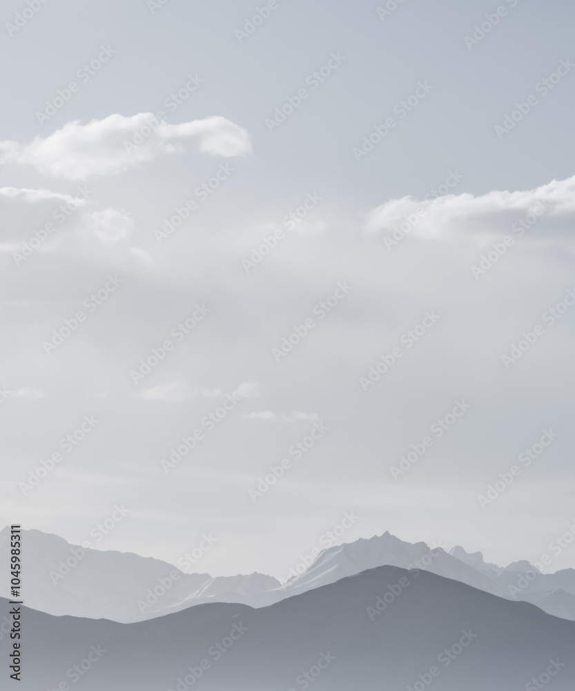 Obraz premium Panoramic minimalist landscape of mountain ranges in Pamir in the Tien Shan Mountains in Tajikistan, silhouette of mountain peaks, landscape for the background