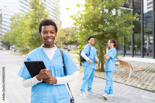 Young nurse students with digital devices outdoors