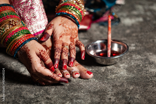 A traditional Indian woman is wearing a silver toe ring on her toe. photo