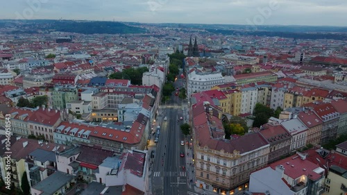 Aerial views capture a tram gliding along Vinohradska Avenue in Prague, with the church of St. Stephen glowing beautifully in the dusk light photo