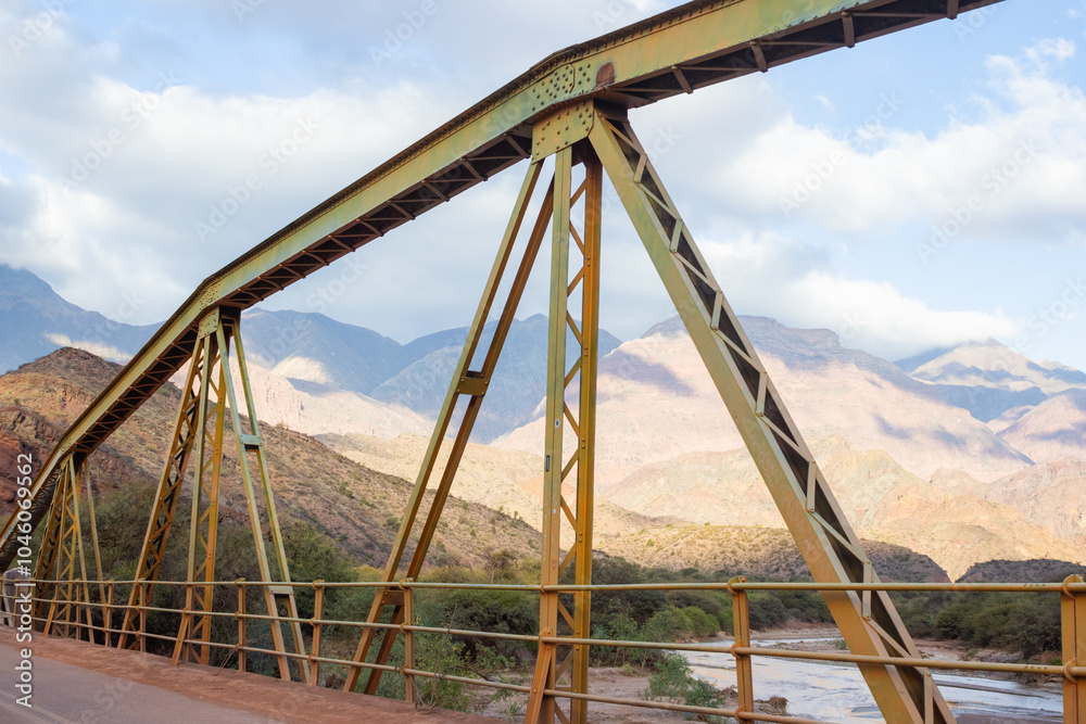 View of an old iron bridge with mountains in the background in Salta, Argentina. View of an old iron bridge with mountains in the background in Salta, Argentina.