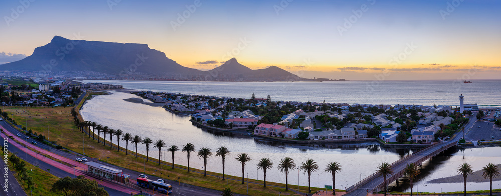 Woodbridge Island and its connecting bridge at twilight, with the lighthouse and the lagoon