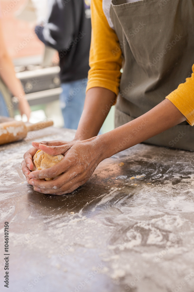 Christmas time, woman kneading dough on floured surface at home kitchen Christmas time, woman kneading dough on floured surface at home kitchen