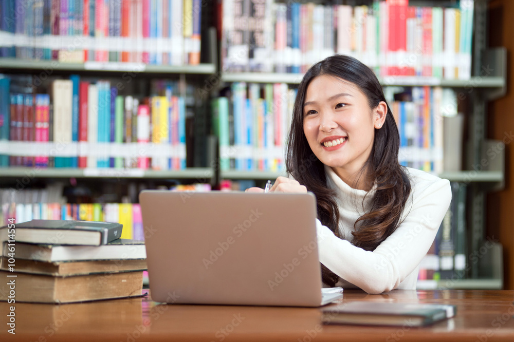 Interesting Asian students in the library, searching for knowledge, studying, doing homework, knowledge and information seeking concept. Interesting Asian students in the library, searching for knowledge, studying, doing homework, knowledge and information seeking concept.