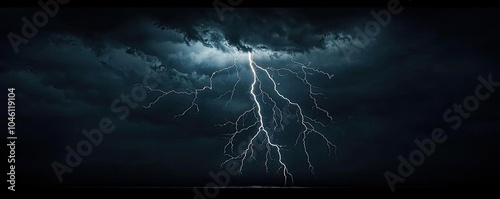 Dramatic lightning strikes in a dark stormy sky. photo