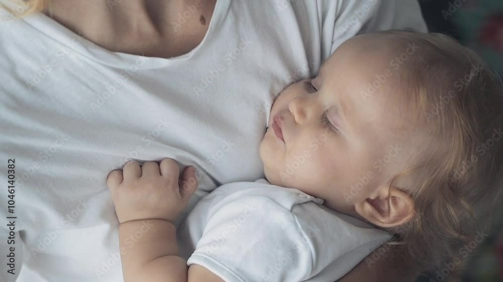 Happy mom holding her sleeping newborn baby on hands, kissing and hugging. Family care, happy childhood and motherhood. Slow motion video, close up Happy mom holding her sleeping newborn baby on hands, kissing and hugging. Family care, happy childhood and motherhood. Slow motion video, close up