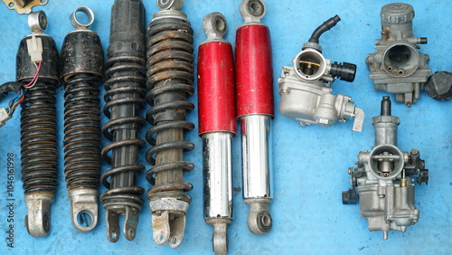 Used motorcycle spare parts at the flea market. Shockbreaker and carburetor