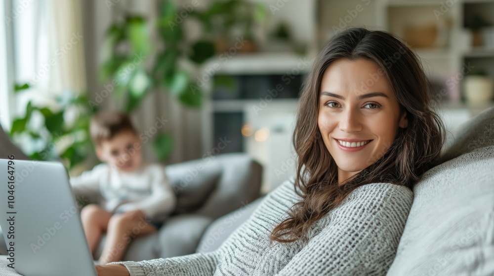 Fototapeta premium Professional photo of a woman sitting on the sofa of her home with in front of a laptop while working from home